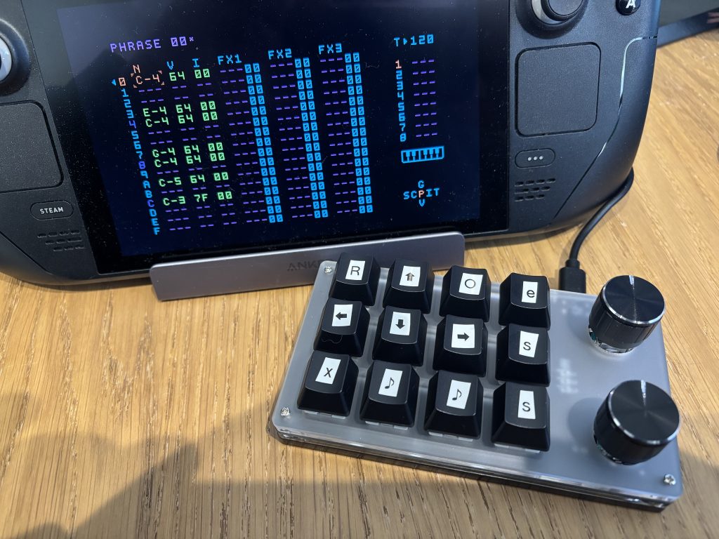 Rough Dymo-labelled keycaps on a keyboard in front of a SteamDeck